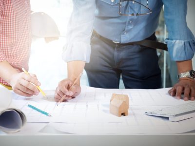 Image of engineer meeting for architectural project. working with partner and engineering tools on workplace vintage tone.